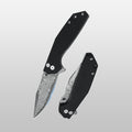 Folding knife with black handle and silver blade on a gray background