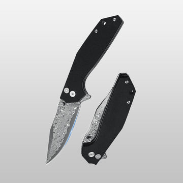 Folding knife with black handle and silver blade on a gray background