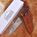 Knife with leather sheath and 'Animas Forge' branding on a wooden surface