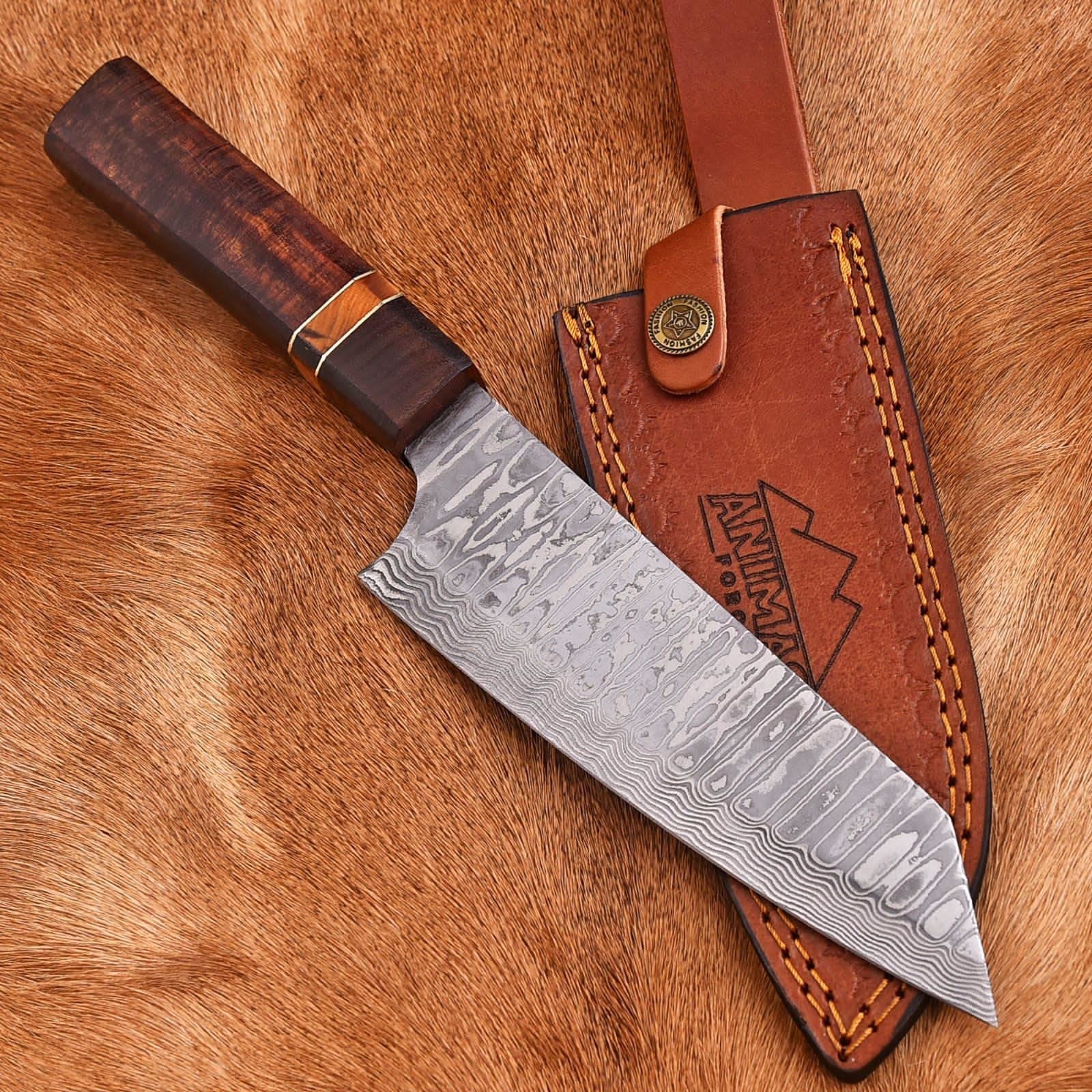 Decorative knife with a leather sheath on a wooden surface