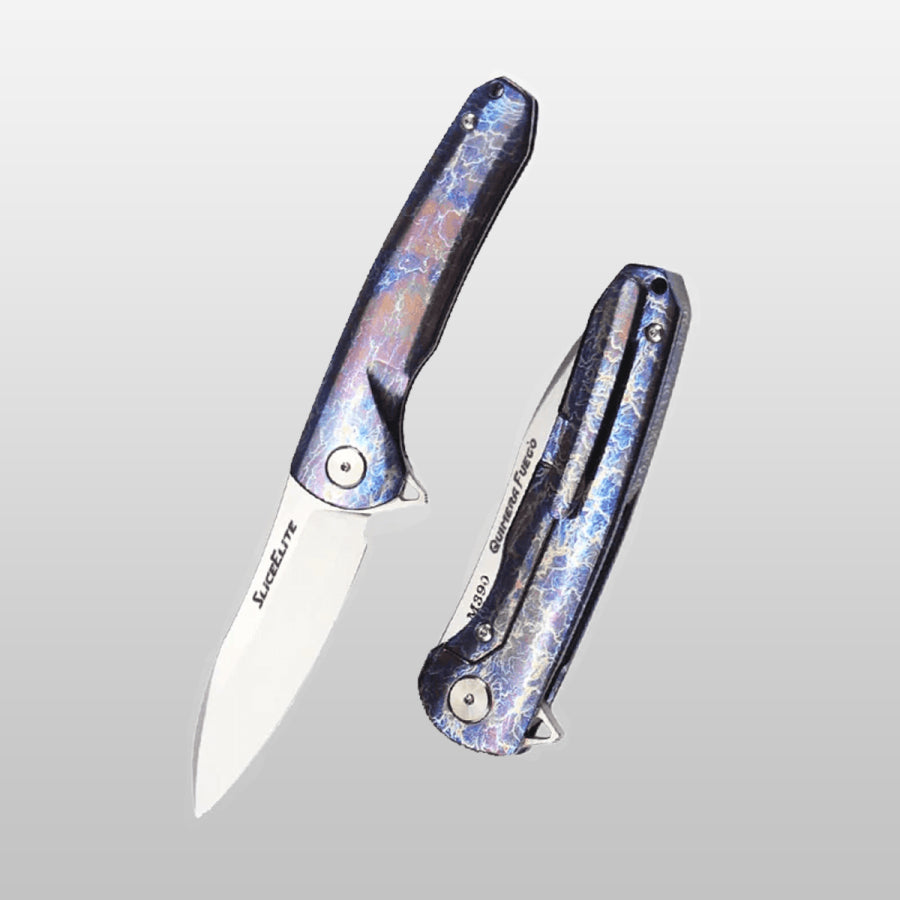 Quimera Fuego EDC Folding knife with iridescent handle on a light gray background