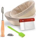 Round rattan banneton proofing basket with linen liner, bread lame, extra blades, dough scraper, and brush for artisan sourdough baking.