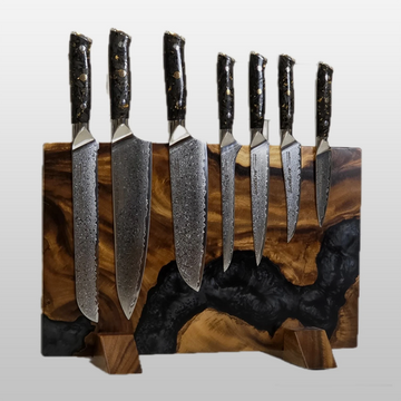 Set of seven knives with black handles on a wooden magnetic  block against a white background