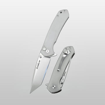 Folding knife with a metallic blade and handle on a light gray background