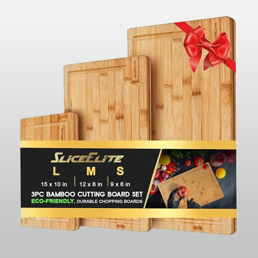 Set of three bamboo cutting boards with a red bow on a gray background