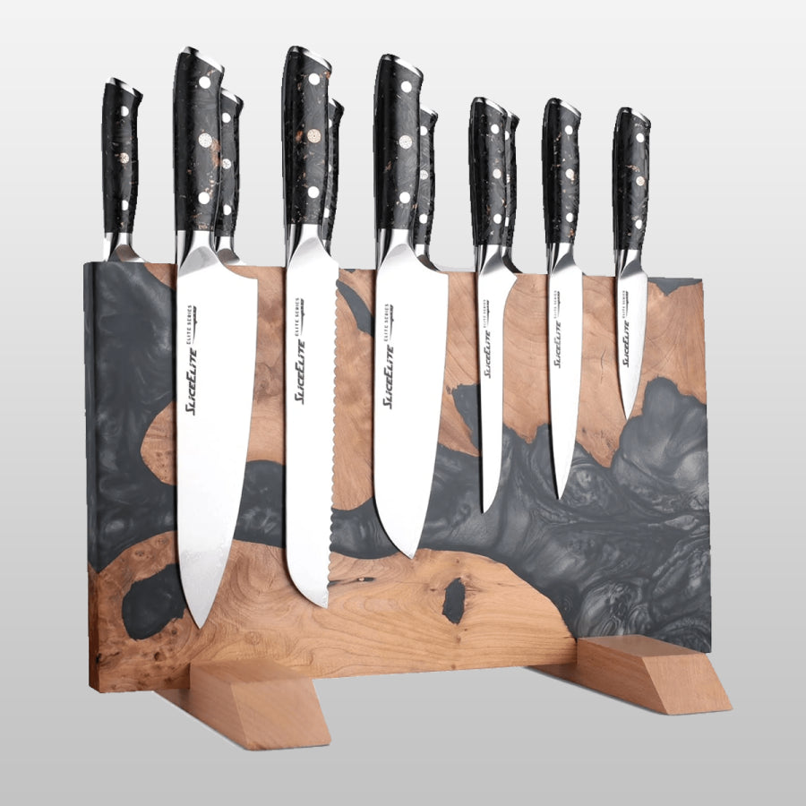 Set of knives with black handles and silver blades on a wooden stand against a gray background