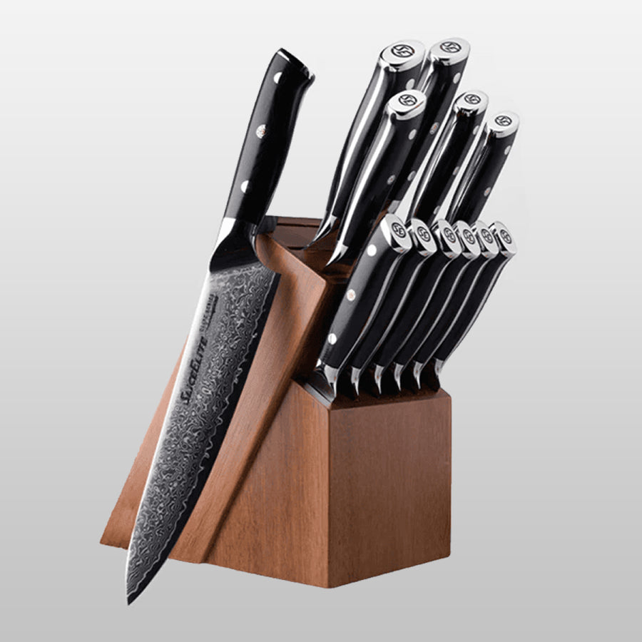 Set of knives with black handles in a wooden block on a light gray background